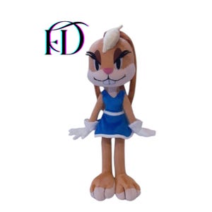 May include: A plush Lola Bunny doll, featuring a blue dress, white gloves, and a light brown fur. The doll has a pink nose, a white tuft of hair, and black eyelashes. The letters "FD" are in the upper left corner.