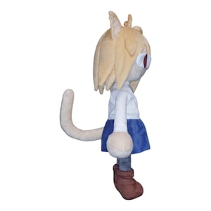 May include: A plush doll of a cat-like character with tan hair and red eyes. The doll wears a white shirt, blue skirt, and brown boots. The doll has a long, curved tail.