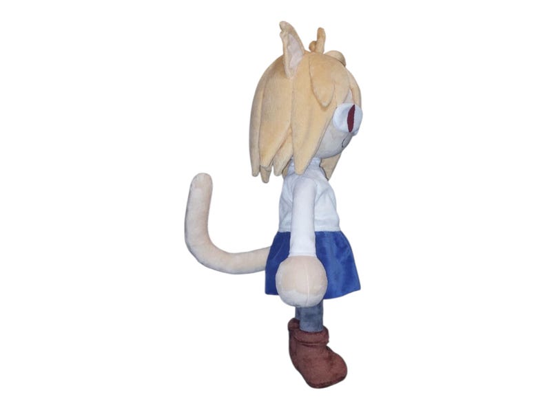 May include: A plush doll of a cat-like character with tan hair and red eyes. The doll wears a white shirt, blue skirt, and brown boots. The doll has a long, curved tail.