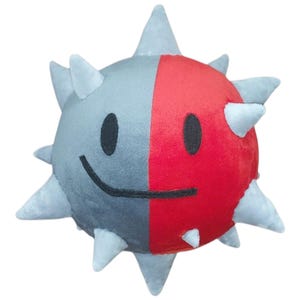 May include: A plush toy in the shape of a spiky ball, split vertically into gray and red halves. The toy has a smiling face with black eyes and a curved mouth. Light gray spikes protrude from the ball's surface.
