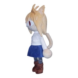 May include: A plush doll of a character with tan hair, cat ears, and red eyes. The doll wears a white shirt, blue skirt, and brown boots. The doll has a long, curved tail and a neutral expression.