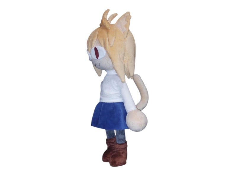 May include: A plush doll of a character with tan hair, cat ears, and red eyes. The doll wears a white shirt, blue skirt, and brown boots. The doll has a long, curved tail and a neutral expression.