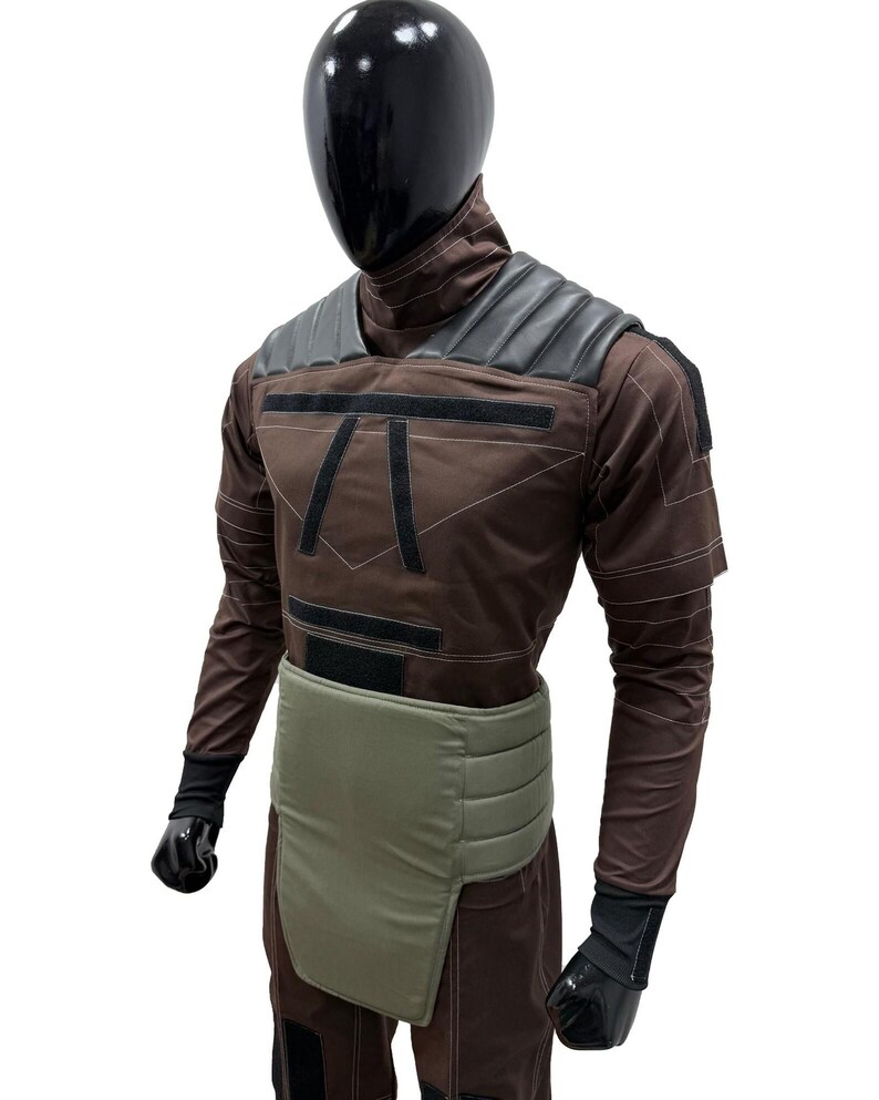 May include: Brown and black costume with a black helmet. The costume features a padded shoulder design, a light green waist protector, and black gloves. The costume has a geometric design on the chest and is made of a durable material.
