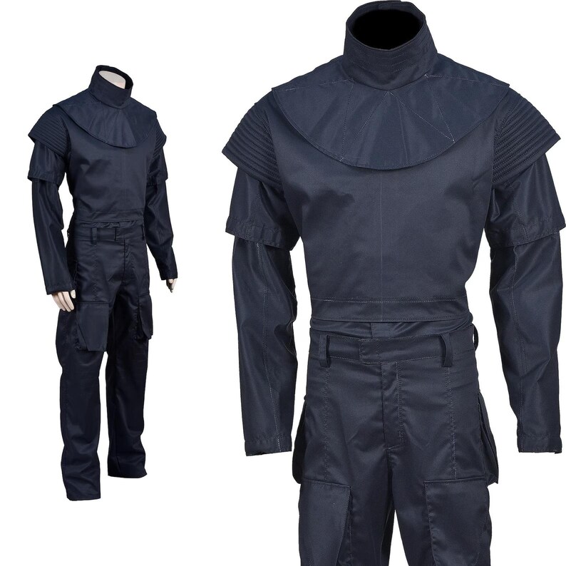 May include: Navy blue jumpsuit with a high collar and layered shoulder details. The long-sleeved garment features a fitted waist and multiple pockets on the pants. The costume is displayed on a mannequin, showcasing its design and fit.