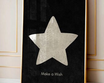 Könnte beinhalten: Gerahmter Kunstdruck mit einem großen, strukturierten Stern in neutralem Beige vor schwarzem Hintergrund. Die Worte "Make a Wish" sind unten in Weiß gedruckt. Der Rahmen ist goldfarben.