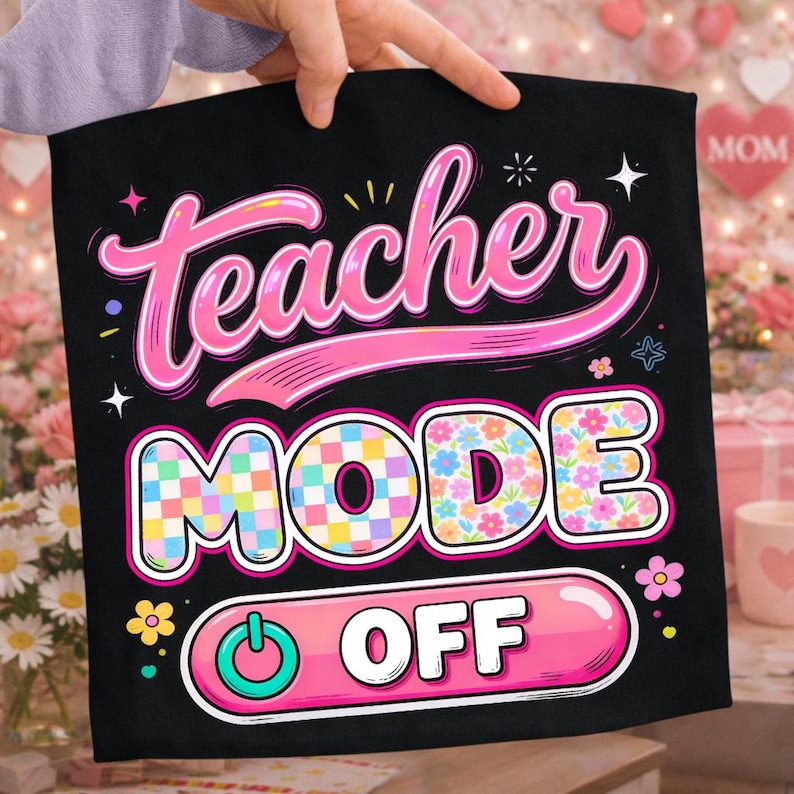 May include: Black decorative pillow with the words "Teacher Mode Off" in pink and white. The word "Teacher" is in a cursive font, and "Mode" is in a checkered pattern. The pillow is held by a person.