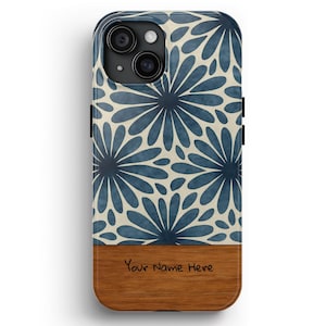 May include: A phone case with a floral design in shades of blue and cream. The top portion features a repeating pattern of stylized flowers, while the bottom has a wood-grain finish with the text "Your Name Here".