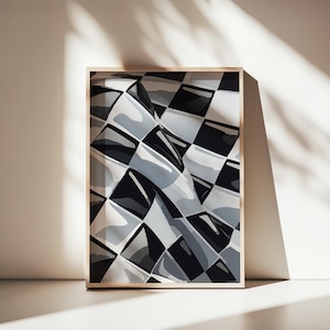 May include: A framed artwork featuring a black, white, and gray checkered pattern with a wavy design. The artwork is displayed in a light-colored wooden frame and leans against a white surface, with shadows cast across the scene.