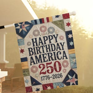 May include: A rectangular flag with the text "HAPPY BIRTHDAY AMERICA 250 1776-2026". The flag has a patchwork design with stars, fireworks, and a red, white, and blue colour scheme. It is displayed on a white pole, suitable for outdoor use.