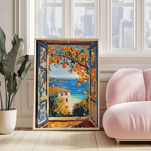 Könnte beinhalten: Ein gerahmter Wandkunstdruck, der den Blick aus einem offenen Fenster auf eine mediterrane Küstenlandschaft zeigt. Das Gemälde zeigt leuchtende Orangen an Ästen, ein blaues Meer, ein Gebäude mit Terrakottadach und blaue Fensterläden.