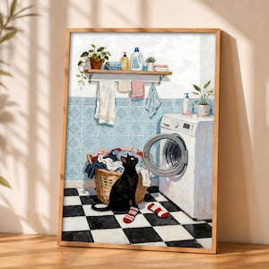 Könnte beinhalten: Ein gerahmter Kunstdruck, der eine Waschküche zeigt, mit einer schwarzen Katze, die auf einem schwarz-weiß karierten Boden neben einem Wäschekorb aus Weidengeflecht und einer weißen Waschmaschine sitzt. Ein Holzregal darüber enthält Flaschen und Pflanzen.