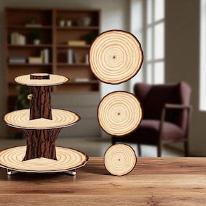 May include: A three-tiered wooden serving stand with a tree trunk-like base and three round, light-colored wooden tiers. Several wooden coasters with a similar design are also present. The wood has a natural grain and a warm, inviting tone.