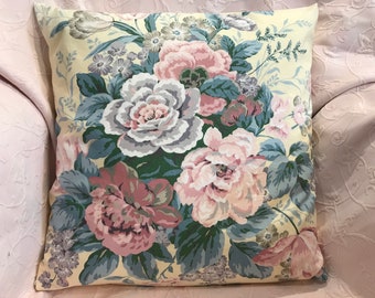 May include: A yellow floral pillow cover with a large bouquet of pink, blue, and green roses. The pillow cover has a vintage style.