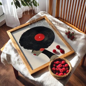 May include: A framed art print featuring a woman's profile with a vinyl record for hair. The artwork has a light background, a wooden frame, and red accents. A small basket of raspberries and scattered berries are also present.