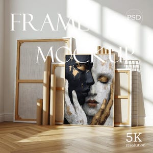 May include: A rectangular frame mockup featuring an abstract painting of two faces, one black and one white, with gold accents. The artwork is displayed among several empty wooden canvas frames and cardboard tubes, with the text FRAME MOCKUP and 5K resolution.