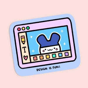 May include: A sticker featuring a cartoon illustration of a digital tablet with a blue and white character on the screen. The tablet has a pink frame and the text "DESIGN IS FUN!" is at the bottom.