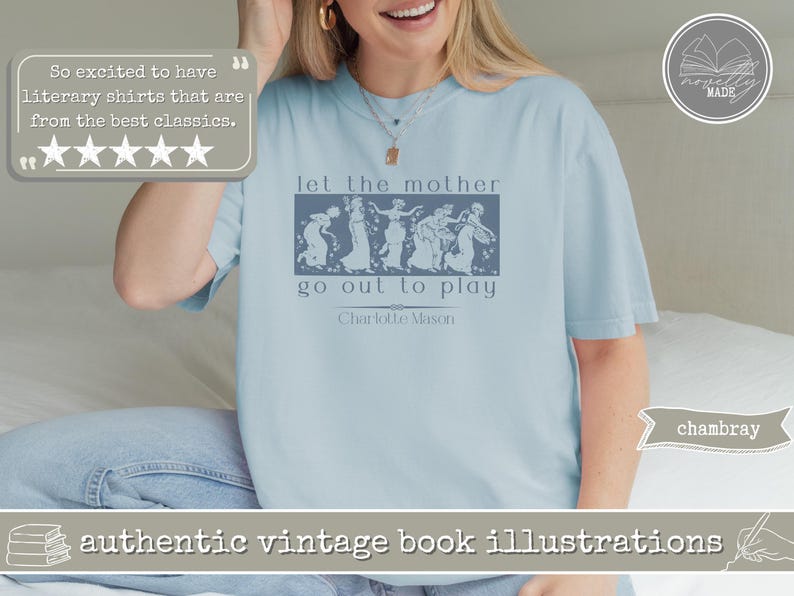 May include: A light blue t-shirt featuring a dark blue rectangular graphic with a vintage-style illustration of five figures dancing. The text reads: let the mother go out to play, followed by the name Charlotte Mason in a simple serif font.