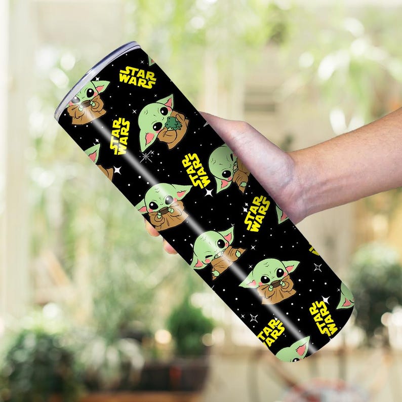 May include: A black, cylindrical tumbler with a repeating pattern of Grogu from Star Wars, and yellow Star Wars logos. The tumbler is likely made of stainless steel.