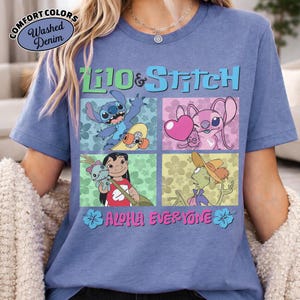 May include: Blue short-sleeved t-shirt with a colourful graphic of characters from Lilo & Stitch. The design includes the text "Lilo & Stitch" and "Aloha Everyone". The shirt has a washed denim appearance.