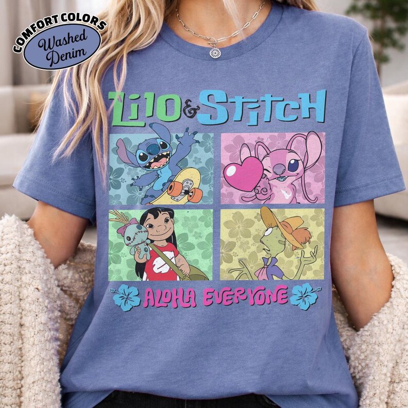 May include: Blue short-sleeved t-shirt with a colourful graphic of characters from Lilo & Stitch. The design includes the text "Lilo & Stitch" and "Aloha Everyone". The shirt has a washed denim appearance.