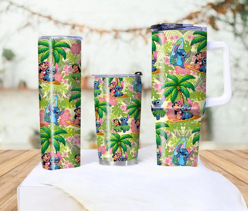 May include: A set of three insulated tumblers featuring a tropical design with palm trees, pink flowers, and cartoon characters. The tumblers include a tall, cylindrical tumbler, a shorter tumbler, and a mug with a white handle.