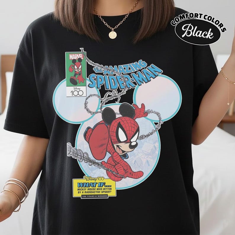 May include: Black t-shirt featuring a Marvel comic-style graphic of Mickey Mouse as Spider-Man. The design includes the text "The Amazing Spider-Man" and "What If... Mickey Mouse Was Bitten by a Radioactive Spider?" with the Disney 100 logo.