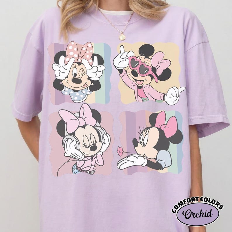 May include: A lilac Comfort Colors t-shirt featuring four images of Minnie Mouse in different poses. Each image is set against a pastel background. Minnie is wearing a pink bow in each image. The shirt has the text "COMFORT COLORS Orchid" at the bottom.