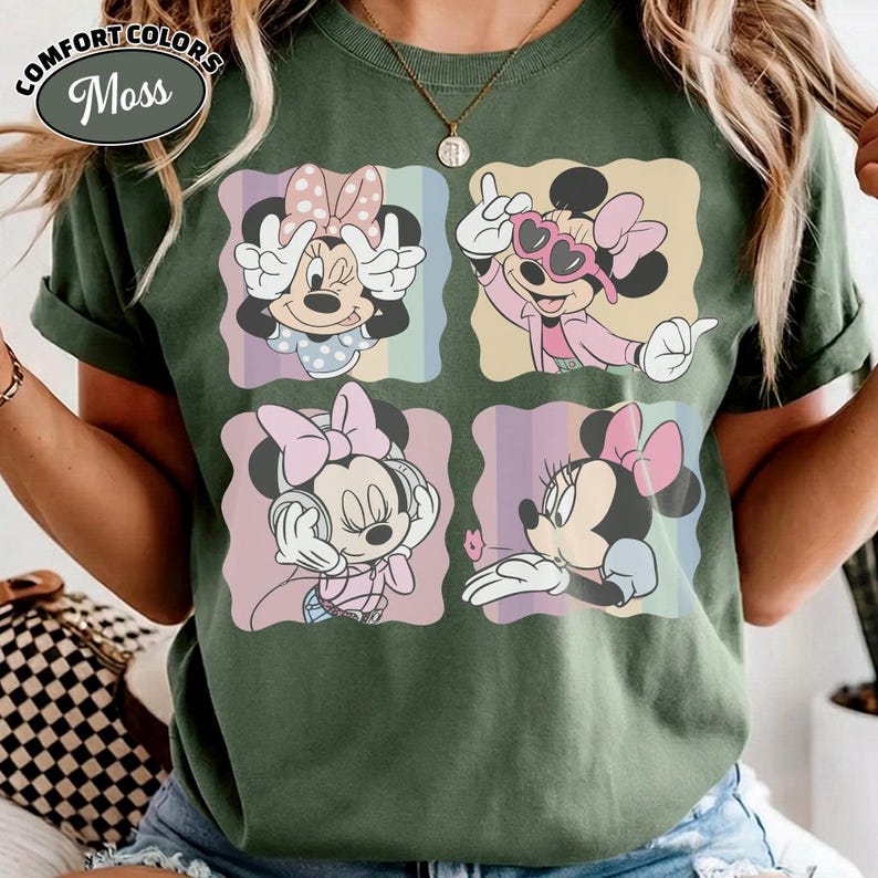 May include: Green Comfort Colors t-shirt featuring four panels with Minnie Mouse illustrations. Each panel showcases a different pose of Minnie Mouse in various outfits and expressions. The shirt has the text "Comfort Colors" and "Moss" in a circular design.