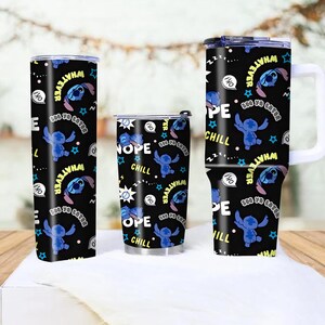 May include: Three black tumblers with a repeating pattern of a blue cartoon character, stars, and text. The text includes "Whatever", "Nope", and "Chill". One tumbler has a handle.