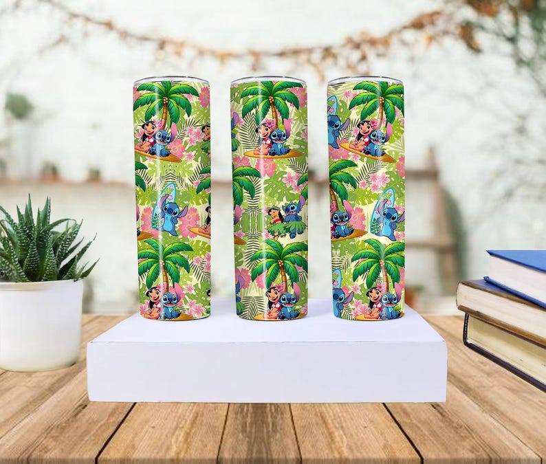 May include: Three stainless steel tumblers with a tropical design featuring palm trees, flowers, and cartoon characters. The tumblers are cylindrical and decorated with a colorful pattern of green, pink, and blue.