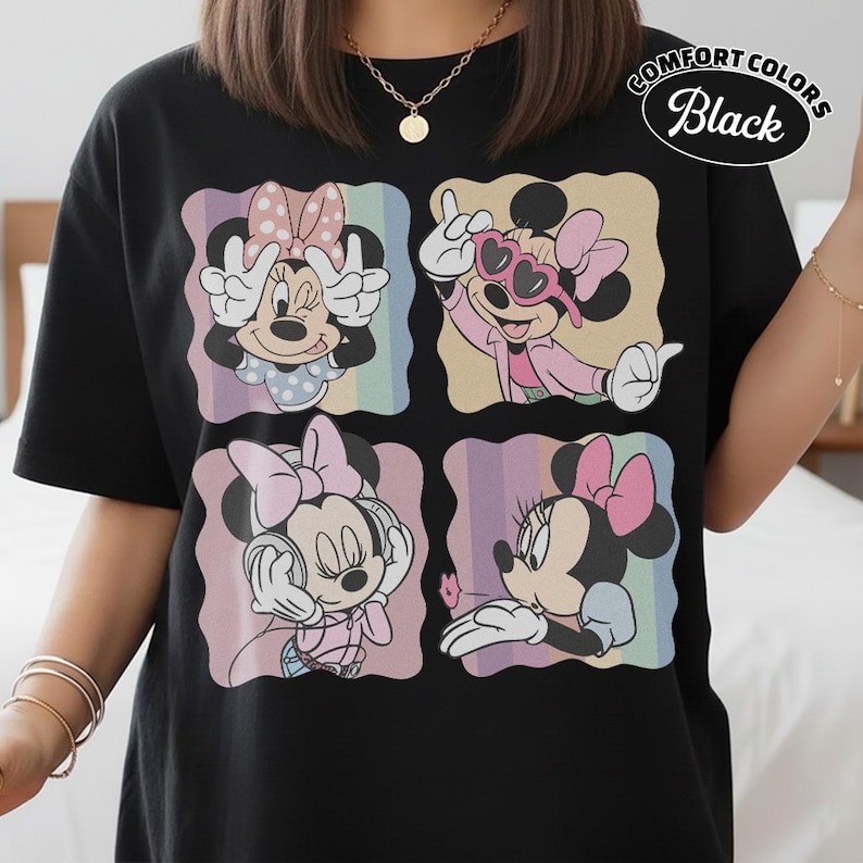 May include: Black t-shirt featuring a four-panel design of Minnie Mouse in various poses. Each panel has a pastel rainbow background. The shirt has the words "Comfort Colors Black" printed on the upper right.