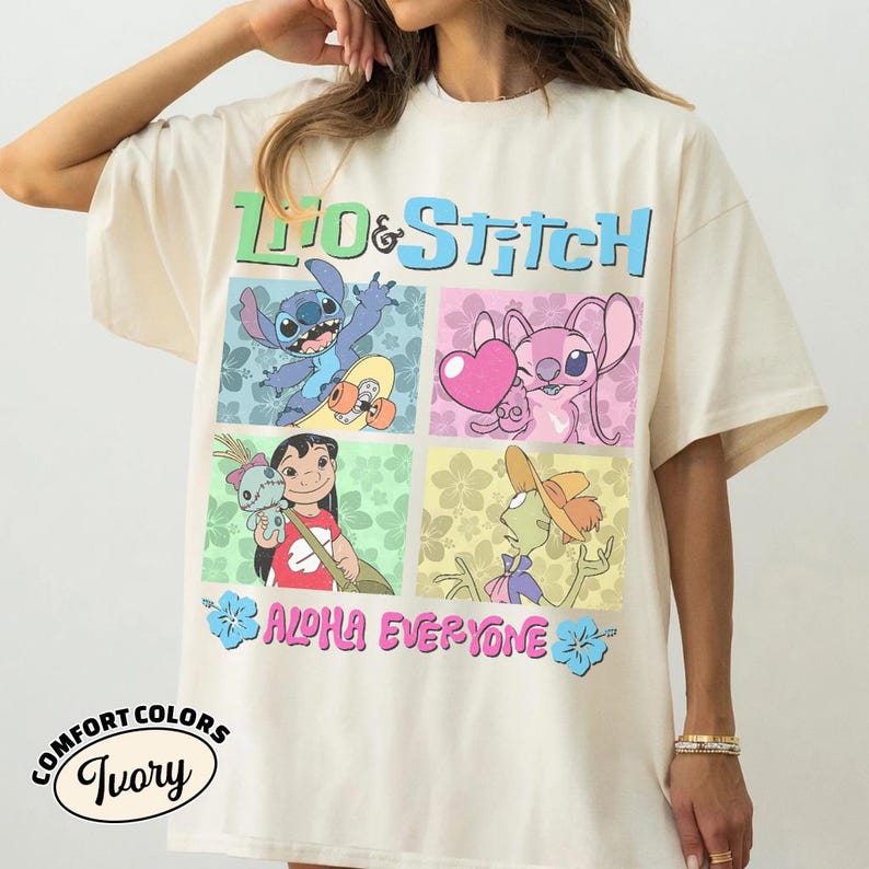 May include: Cream-coloured t-shirt with a vibrant Lilo & Stitch graphic. The design showcases Stitch on a skateboard, Angel with a heart, Lilo with a doll, and a character with a hat. Text reads "Lilo & Stitch" and "Aloha Everyone."