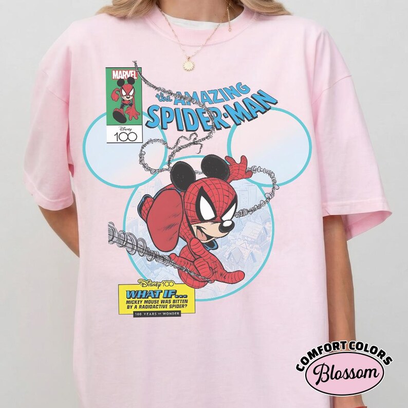 May include: Light pink t-shirt featuring a comic book-style graphic of Mickey Mouse as Spider-Man. The design includes the text "The Amazing Spider-Man," "What If... Mickey Mouse Was Bitten By A Radioactive Spider?" and the Marvel and Disney logos.