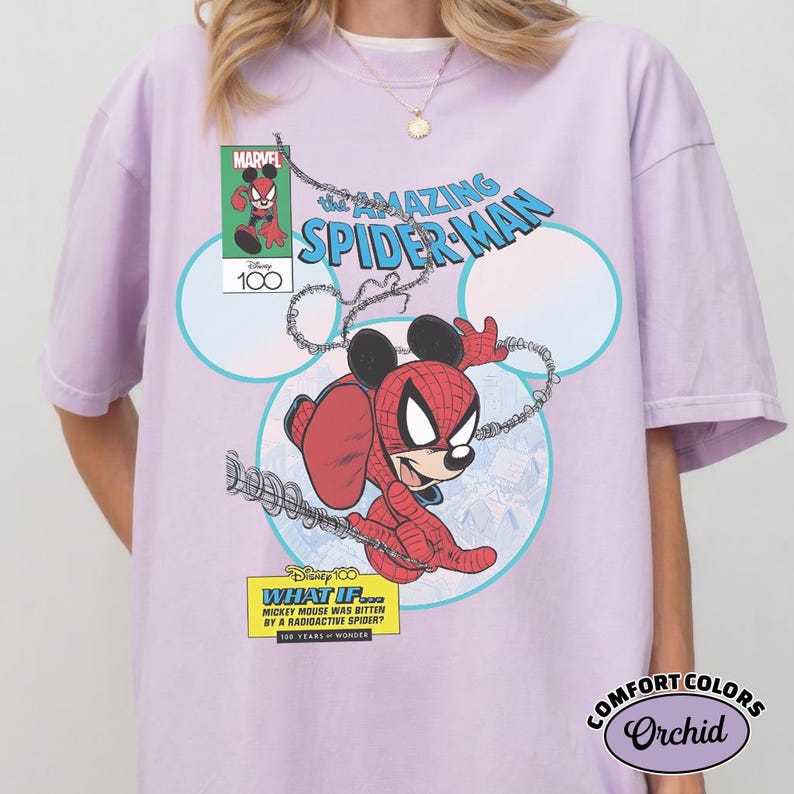 May include: A light purple t-shirt featuring a Marvel comic book-style graphic of Mickey Mouse as Spider-Man. The design includes the text "The Amazing Spider-Man" and "What If... Mickey Mouse Was Bitten By A Radioactive Spider?"