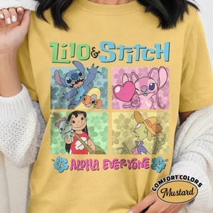 May include: Mustard yellow t-shirt with a vibrant Lilo & Stitch design. The graphic showcases Stitch, Angel, Lilo, and Jumba in square panels. Text includes "Lilo & Stitch" and "Aloha Everyone". The t-shirt is a Comfort Colors brand.