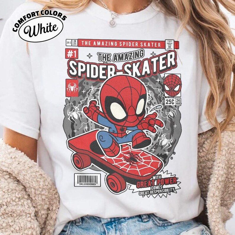 Puede incluir: Camiseta blanca con un dise&ntilde;o de c&oacute;mic de Spider-Man en monopat&iacute;n. El dise&ntilde;o incluye el texto "THE AMAZING SPIDER-SKATER" y "WITH GREAT POWER COMES GREAT RESPONSIBILITY". La camiseta est&aacute; etiquetada como "COMFORT COLORS".