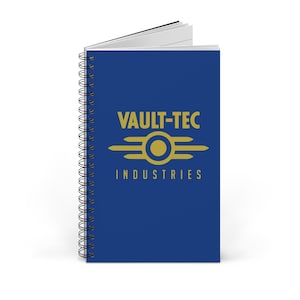 Może przedstawiać: Spiralny notatnik z granatową okładką z logo Vault-Tec Industries w kolorze złotym. Logo zawiera tekst "VAULT-TEC" nad stylizowanym okręgiem i liniami, z napisem "INDUSTRIES" poniżej.