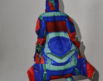 May include: A hooded coat and matching leggings in a vibrant abstract pattern of red, blue, and green. The coat has a long, flowing design, and the leggings are form-fitting. The outfit is paired with black sneakers and sandals.