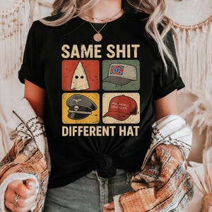 May include: Black t-shirt with the text "SAME SHIT DIFFERENT HAT" and four images of hats. The images include a white hood, a Confederate flag hat, a military hat, and a red "Make America Great Again" hat.
