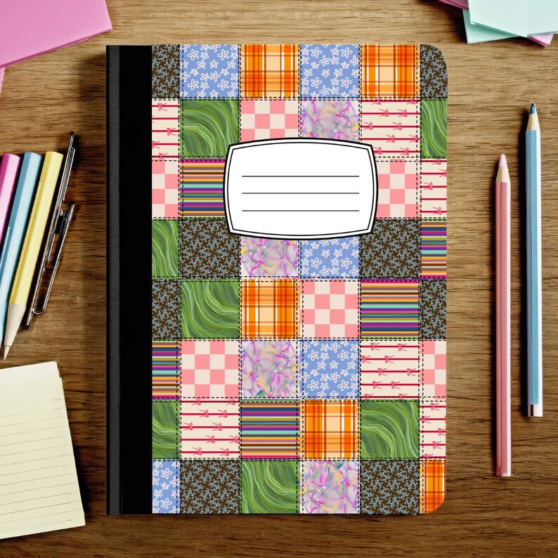May include: A composition notebook with a black spine and a cover featuring a colorful patchwork quilt pattern of squares in orange, green, pink, and blue. A white rectangular label with four horizontal lines is centered on the front cover.