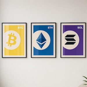 May include: Three framed posters with cryptocurrency symbols. The first poster has a yellow background with the Bitcoin symbol and the letters "BTC". The second poster has a blue background with the Ethereum symbol and the letters "ETH". The third poster has a purple background with the Solana symbol and the letters "SOL".