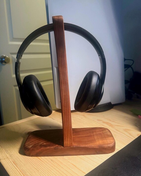 Solid walnut headphone stand with clean modern lines — the kind of desk object that makes cheap plastic stands look embarrassing.