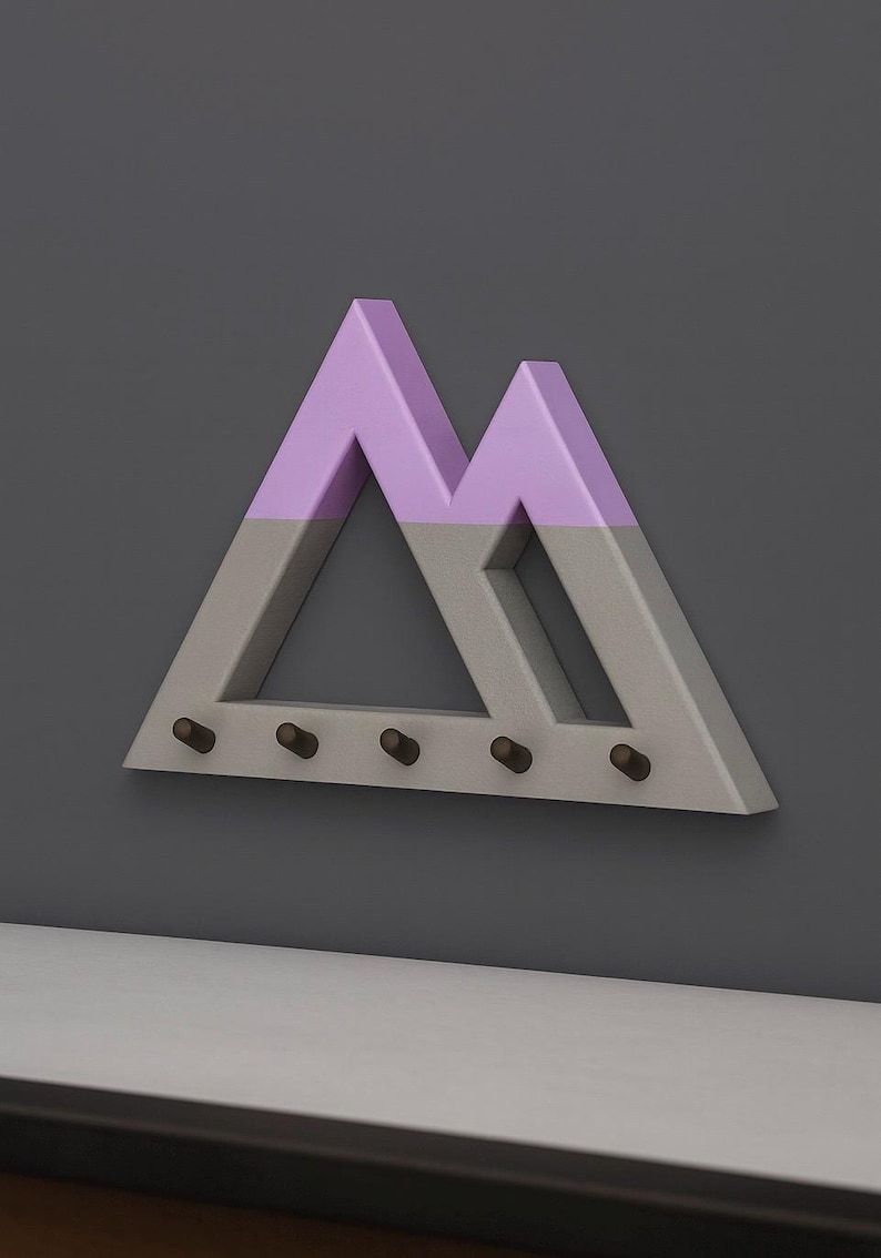 Gray Mountain key holder with lilac peaks on a dark charcoal wall above a pale ledge, angled to show its depth