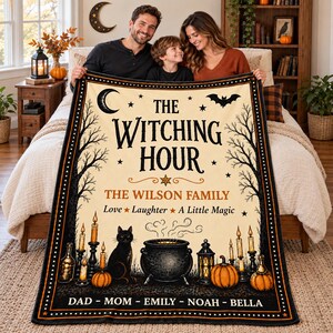 May include: A cream-colored throw blanket featuring a black crescent moon, a bat, bare trees, a black cat, a cauldron, pumpkins, and candles. The text reads THE WITCHING HOUR, THE WILSON FAMILY, Love Laughter A Little Magic, and DAD MOM EMILY NOAH BELLA.