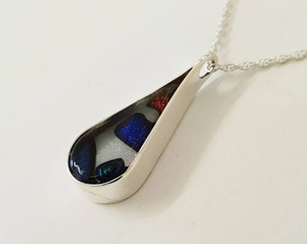 Dichroic glass in silver surround pendant.