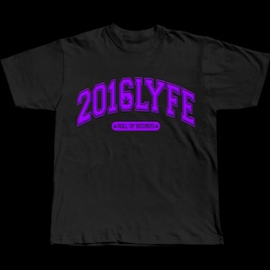 May include: Black t-shirt featuring the purple text "2016LYFE" in an arched style. Beneath, the text "ROLL UP RECORDS" is displayed. The shirt is made of a soft material.