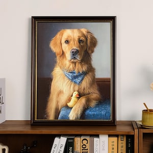 May include: A framed portrait of a Golden Retriever dog wearing a blue bandana and holding a yellow rubber duck. The dog is depicted sitting on a blue cushion. The frame is dark brown.