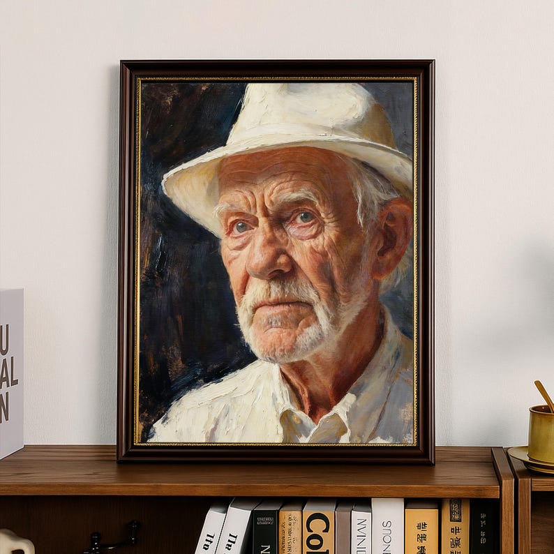 May include: A framed portrait of an elderly person wearing a white hat and shirt. The painting shows a detailed depiction of the person's face, with visible wrinkles and a white beard. The frame is dark brown.
