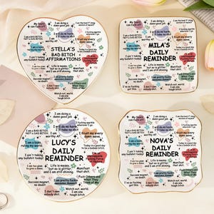 May include: Four decorative ceramic coasters with inspirational affirmations. The coasters are in various shapes: heart, square, and irregular. Each coaster has a different name: Stella's, Mila's, Lucy's, and Nova's.