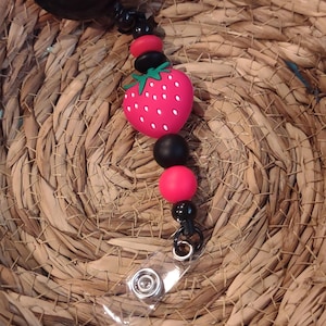 Strawberry Badge Reel. High quality badge reel, red and black beads. Use promo code BUY3SAVE5DOLLARS when you purchase 3 items or more.